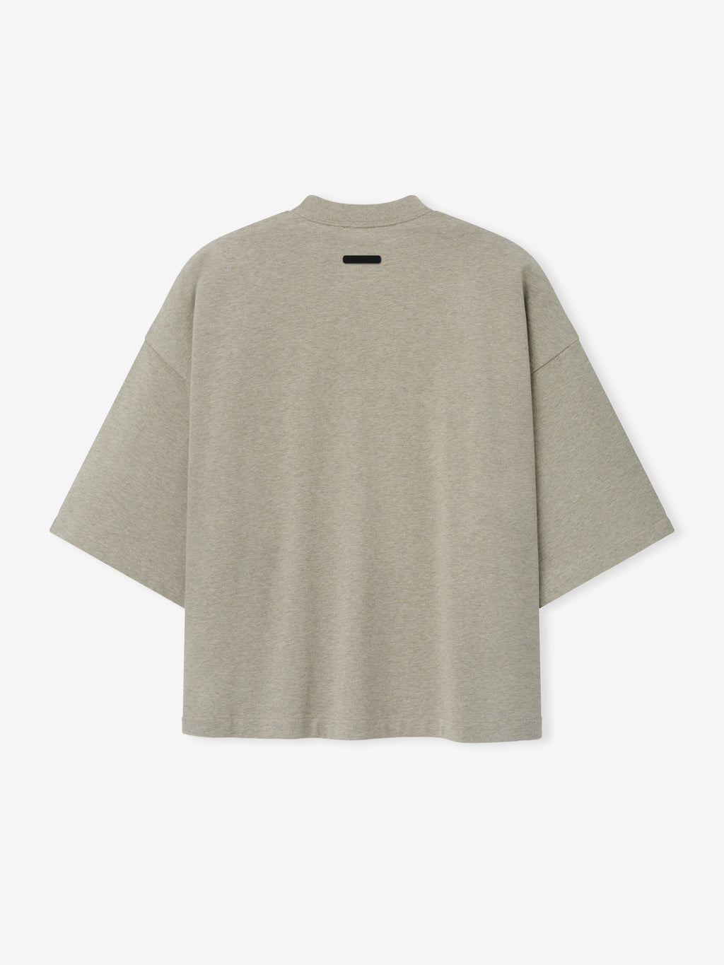 Merch Tee in soft heathered seal tone featuring an oversized relaxed fit with dropped shoulders and a subtle black tag detail on the upper back for a minimalist casual top.