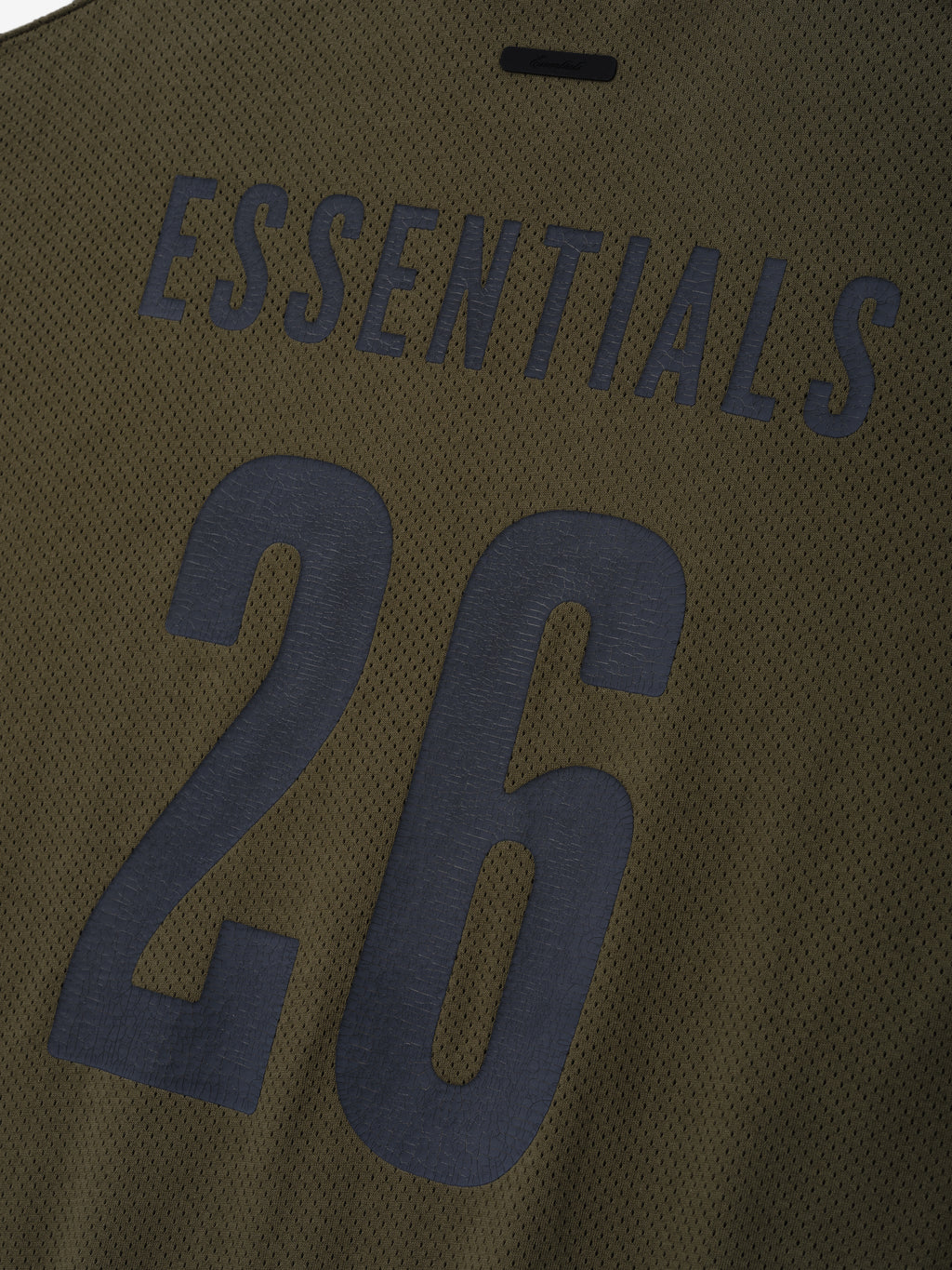 Sport Mesh Merch Long Sleeve Tee in moss green mesh fabric featuring bold dark navy "ESSENTIALS" text and the number 26 on the back for a modern sporty top.