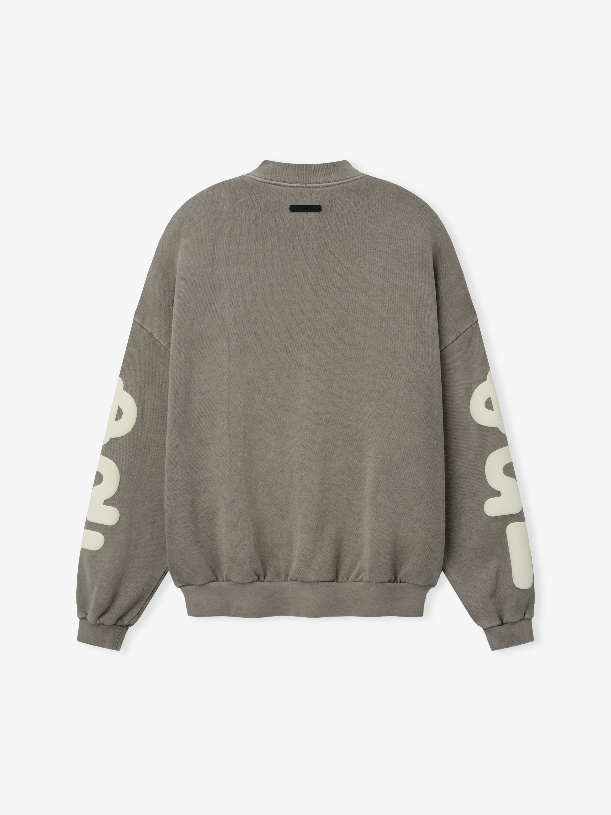 90'S Sweatshirt in a muted washed seal tone, showcasing a relaxed fit with dropped shoulders, ribbed cuffs and hem, and large contrasting lettering printed along the sleeves for casual tops.
