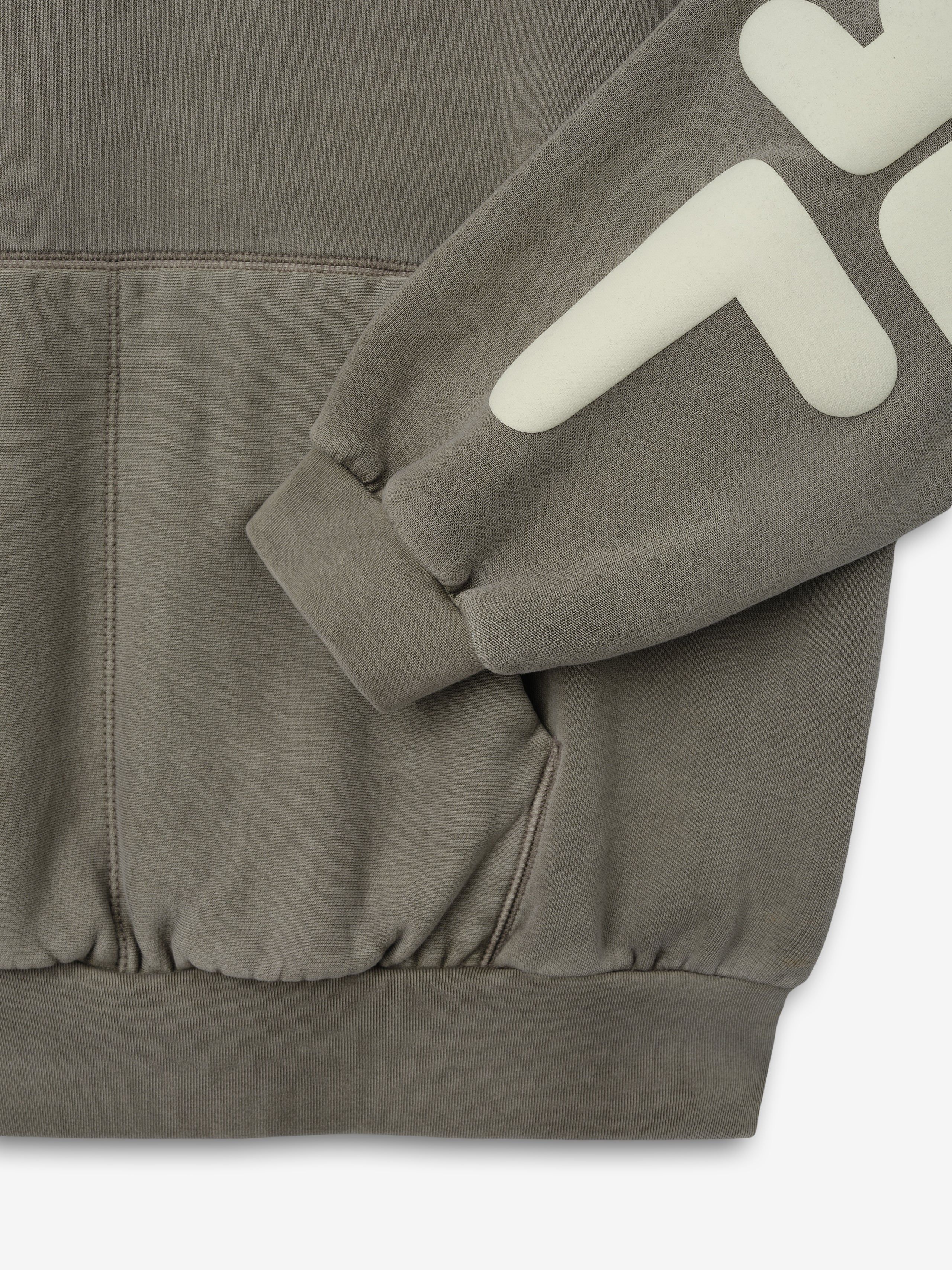 90'S Sweatshirt in a muted washed seal tone, featuring a soft fabric, ribbed cuffs and hem, front pouch pocket, and bold cream graphic print on the sleeve for casual tops.