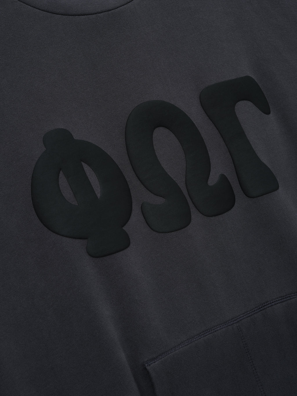 90s Sweatshirt in a deep washed iron grey tone featuring large matte black Greek letter appliqués across the chest and a front kangaroo pocket for casual tops.