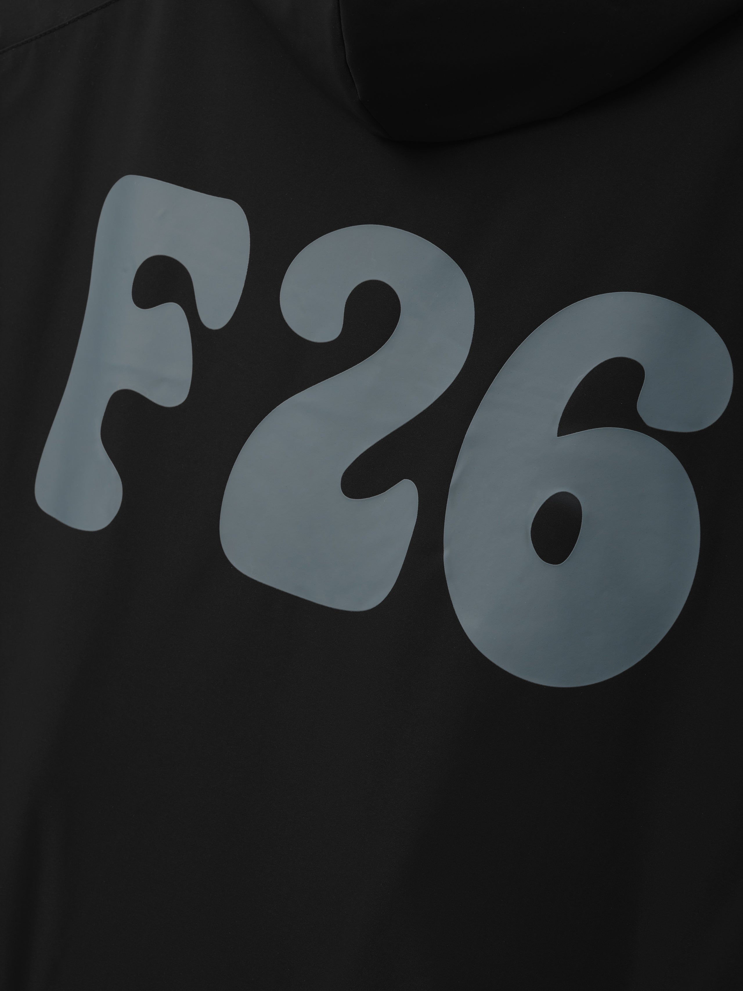 Womens Full Zip Anorak in vintage black featuring bold graphic lettering on the back, made from lightweight fabric with an attached hood for stylish outerwear.
