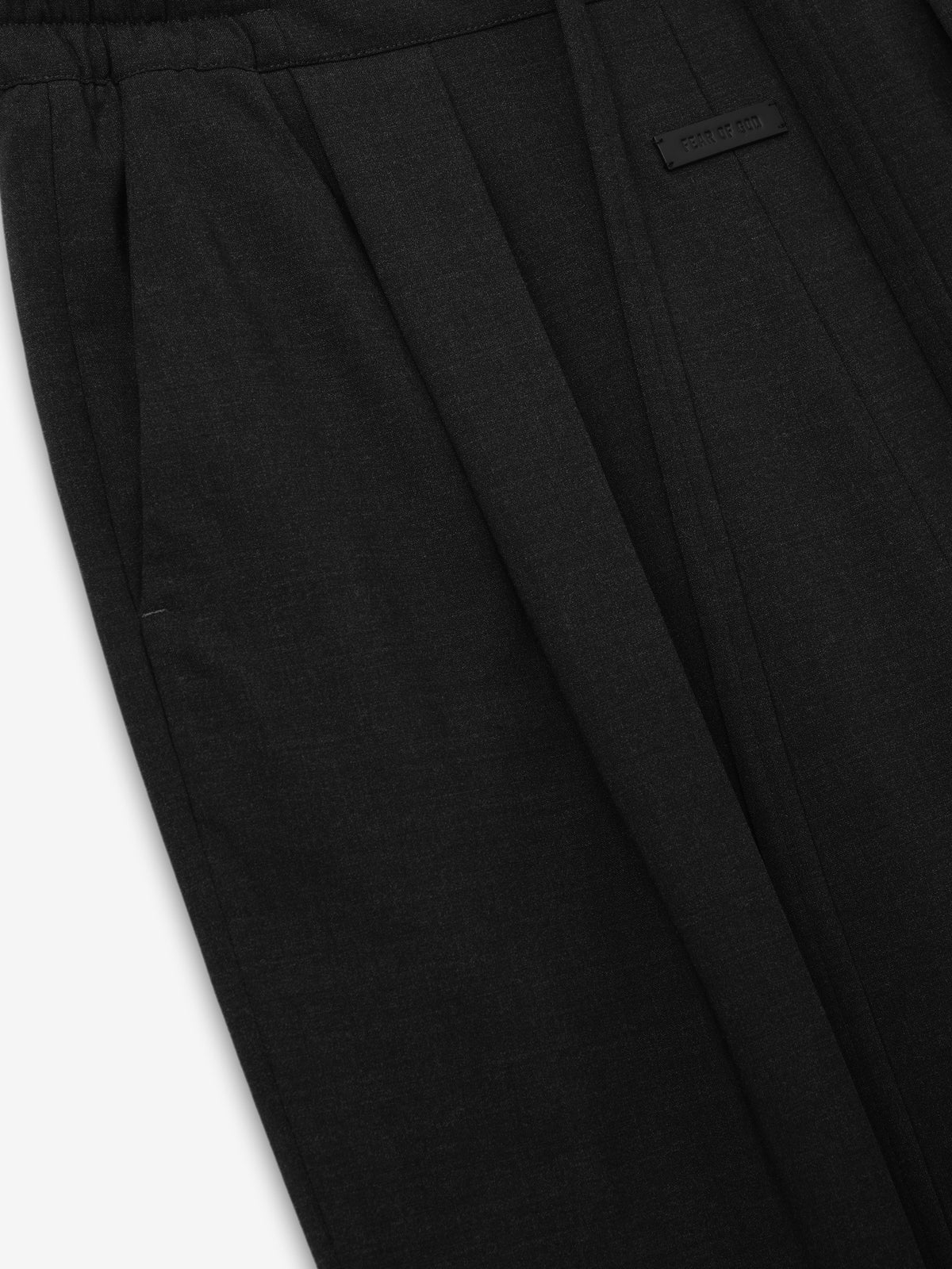 Melange Wool Box Pleat Drawstring Pants in black shown close up with a gathered drawstring waistband front pleats concealed fastening and a small stitched label