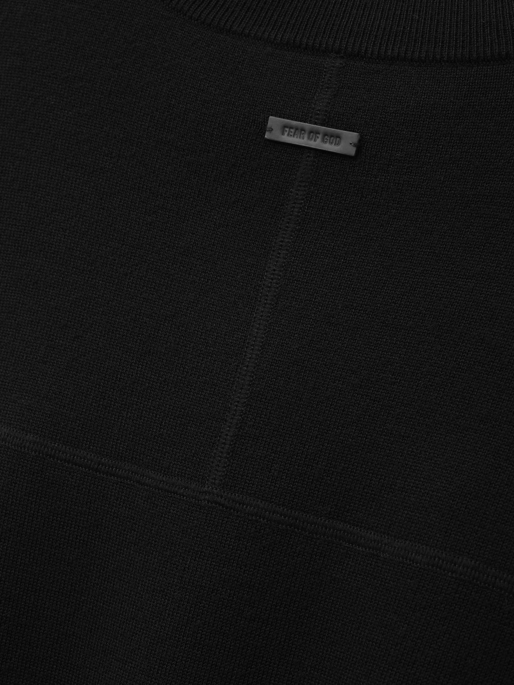 Merino Double Knit Mockneck Sweater in black shown close up with fine knit texture mockneck ribbing tonal seam detail and Fear of God label as Tops