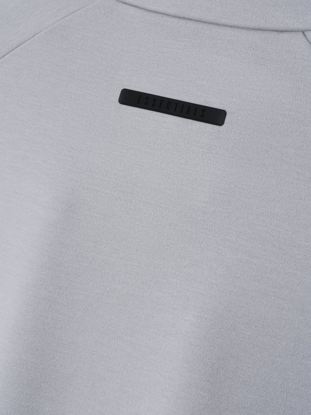 Womens Half Zip Mockneck in light gray shown close up with a tonal Essentials logo label and fine knit texture as Tops