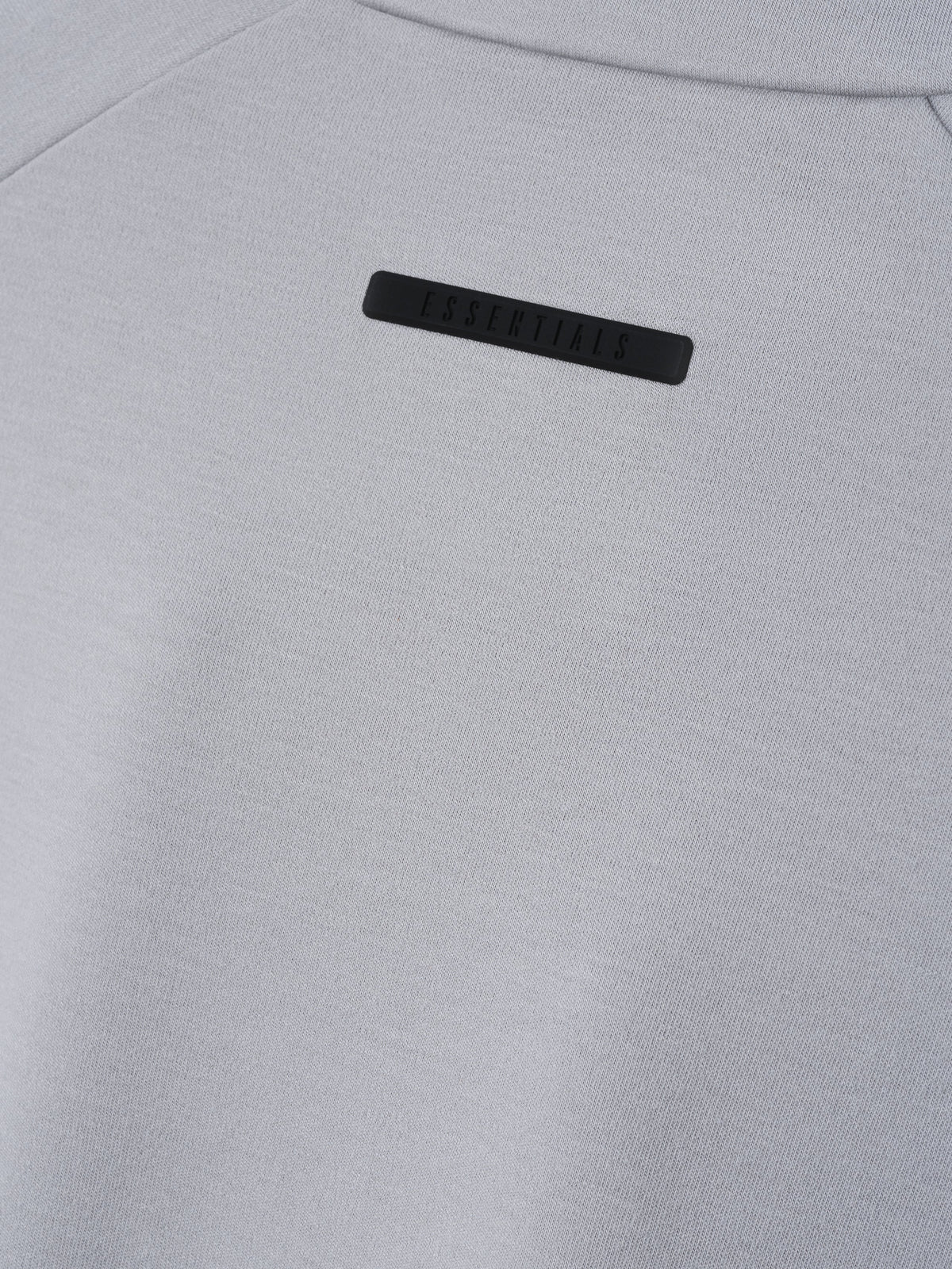 Womens Half Zip Mockneck in light gray shown close up with a tonal Essentials logo label and fine knit texture as Tops