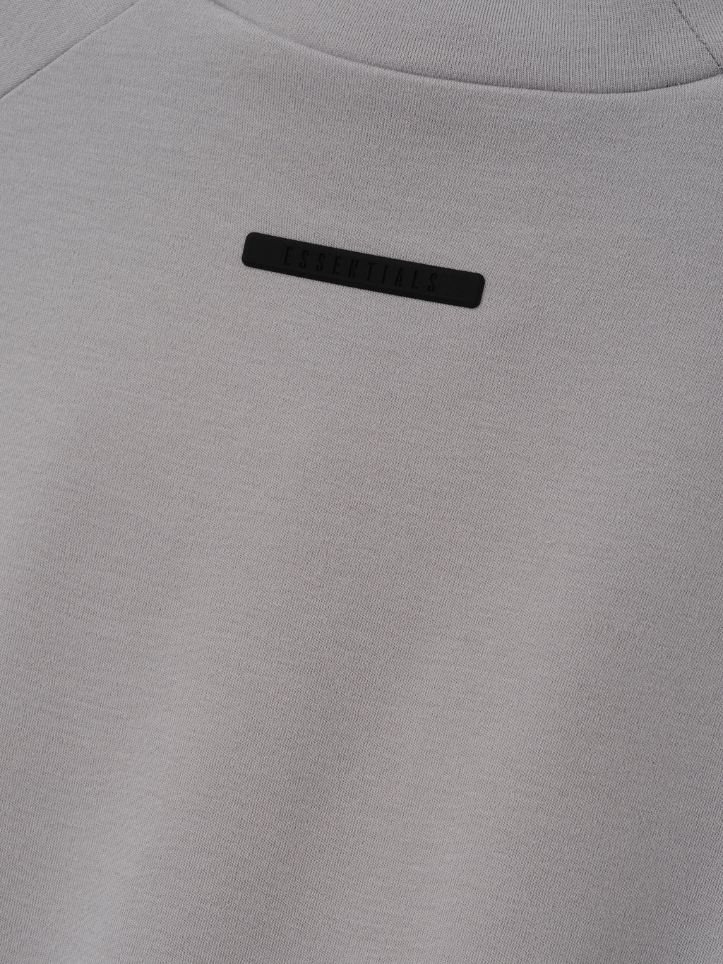 Womens Tight Tee in light gray shown close up with a subtle black chest label and smooth fabric texture against a clean background as Tops