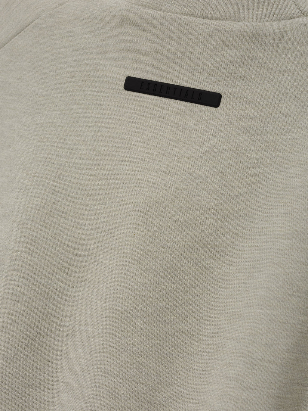 Womens Tight Tee in light gray shown close up with a subtle black chest label and fine knit texture against a clean background as Tops