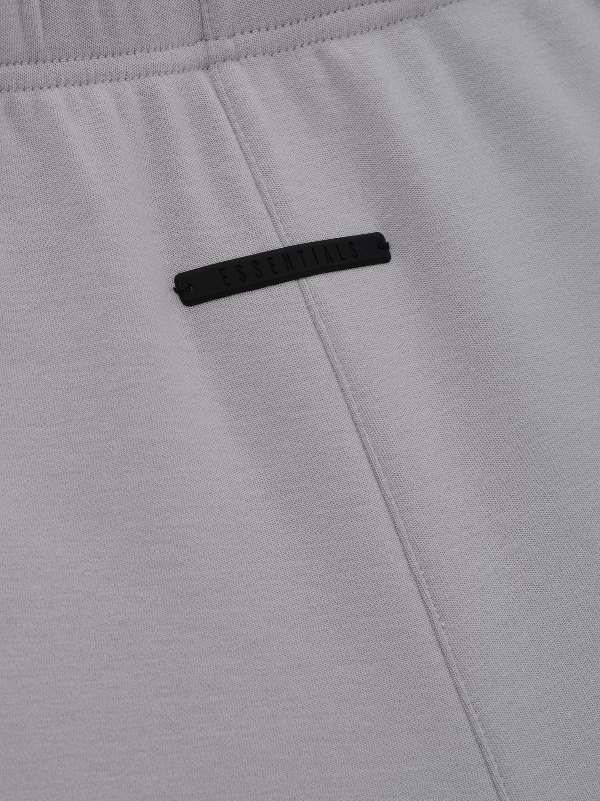 Womens Short in light gray shown close up with a black front label central stitched seam and elastic waistband highlighting the soft fabric texture as Bottoms