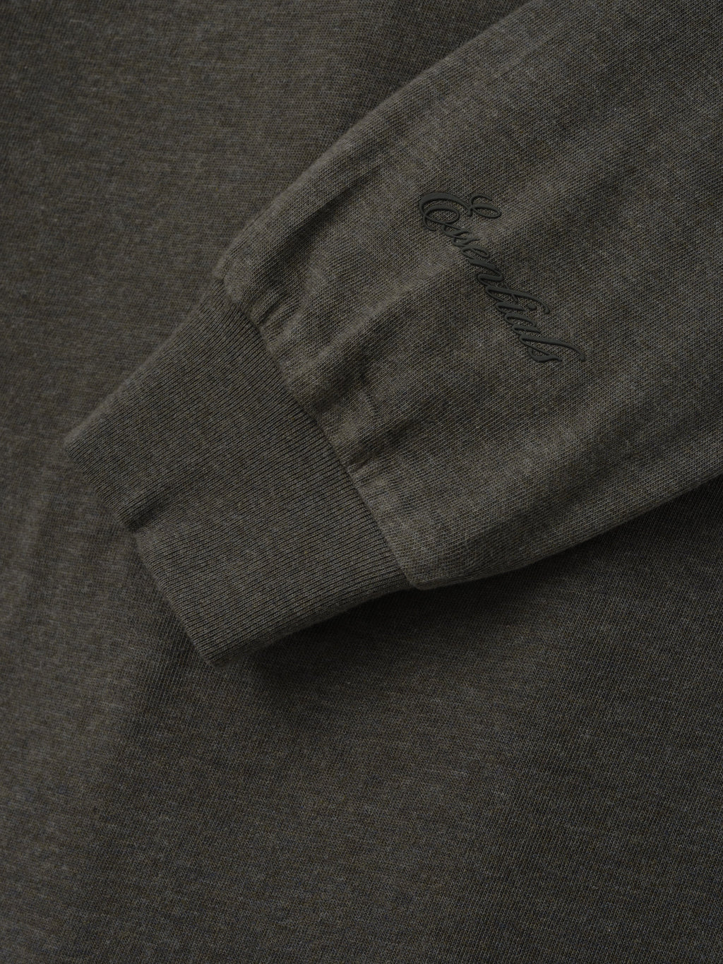 Womens Essential Longsleeve Tee in charcoal shown close up with a ribbed cuff and tonal sleeve branding highlighting the soft fabric texture as Tops