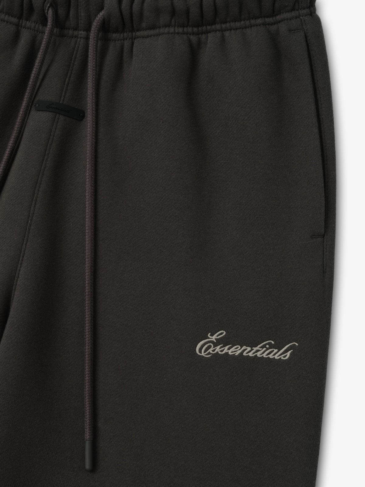 Womens Slim Sweatpant in black shown close up with an elastic waistband drawstring closure side pocket and Essentials script branding as Bottoms
