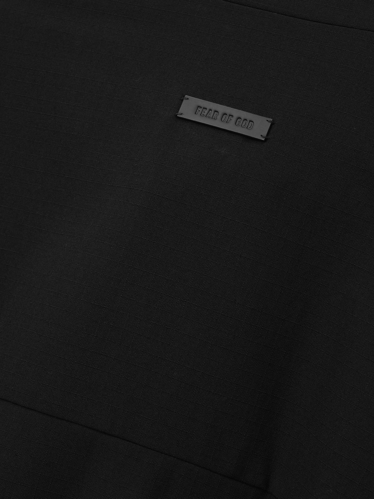 Wool Ripstop Leisure Jacket in black shown in close detail with subtle ripstop texture and a Fear of God label as Outerwear