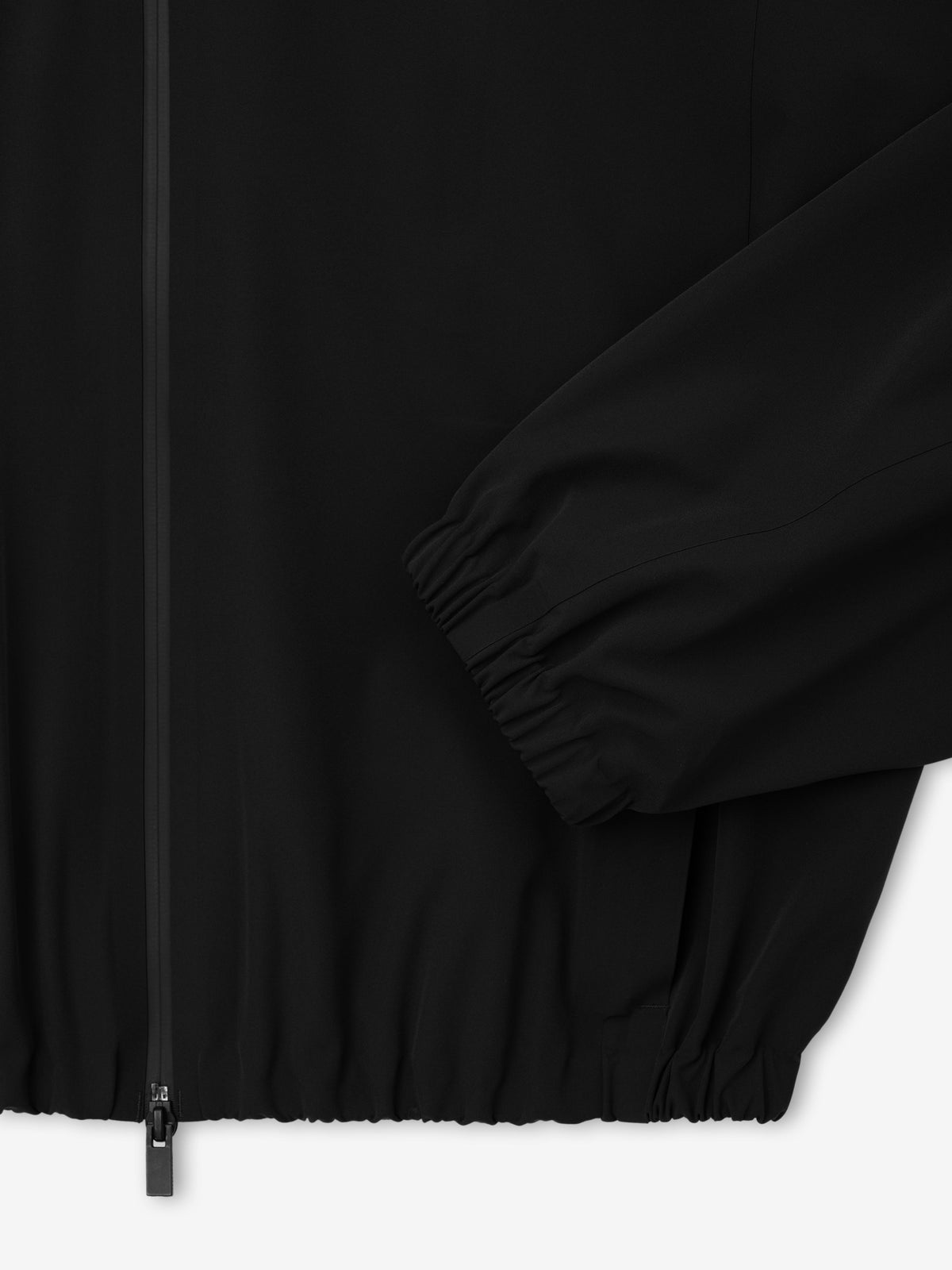 Bonded Nylon Track Jacket in black shown close up with a front zipper gathered sleeve cuff and elastic hem as Outerwear