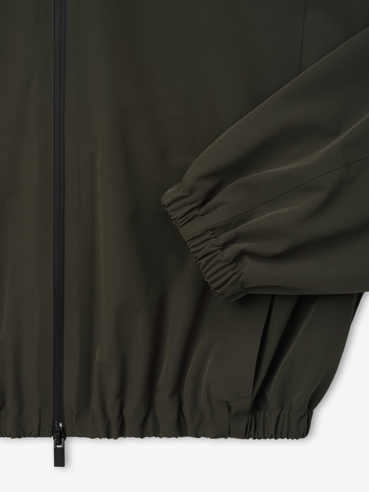 Bonded Nylon Track Jacket in dark olive shown close up with a front zip closure gathered sleeve cuff elastic hem and side pocket as Outerwear