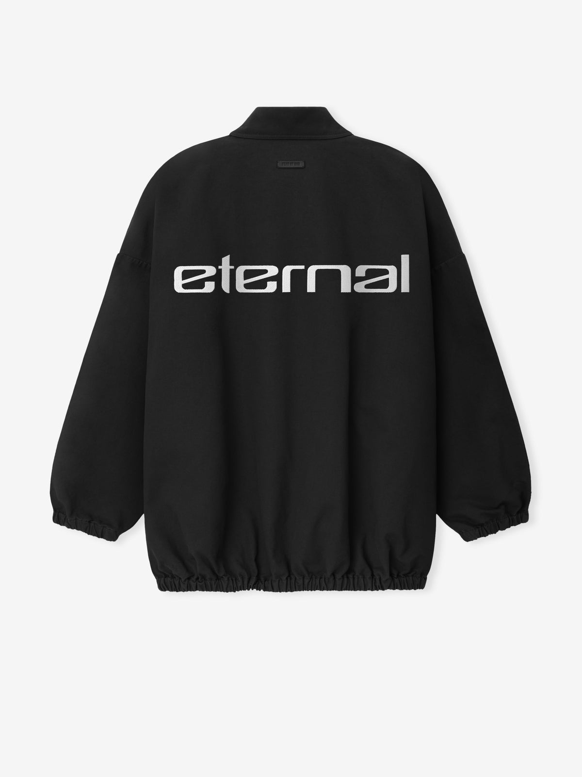 Bonded Nylon Tech Windbreaker in black shown flat from the back with a stand collar elastic cuffs gathered hem and large Eternal graphic as Outerwear