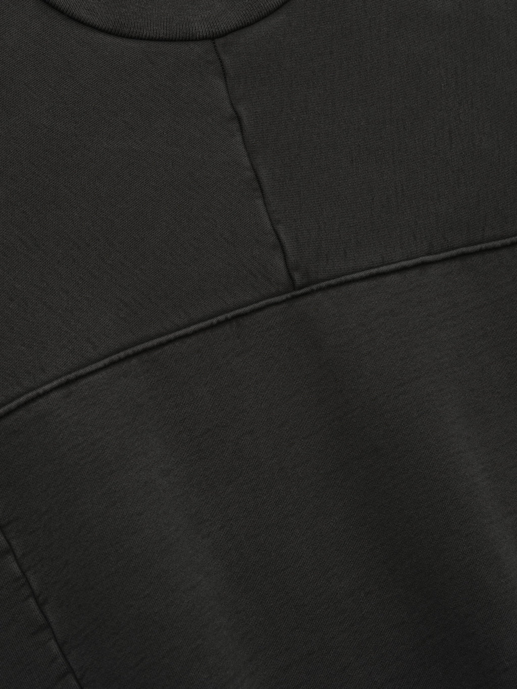 Heavy Fleece Crewneck in black shown in close detail with a ribbed neckline and paneled seam construction across the fleece body as Tops