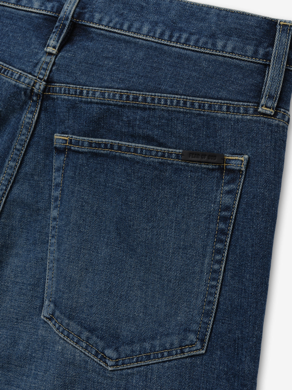 Relaxed Fit Jeans in dark blue denim shown in close detail with a rear patch pocket belt loop waistband and contrast stitching as Bottoms