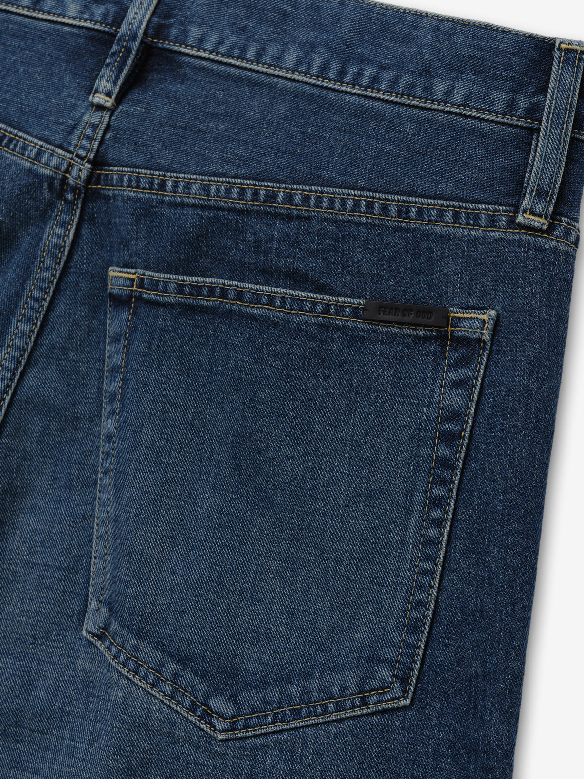 Relaxed Fit Jeans in dark blue denim shown in close detail with a rear patch pocket belt loop waistband and contrast stitching as Bottoms