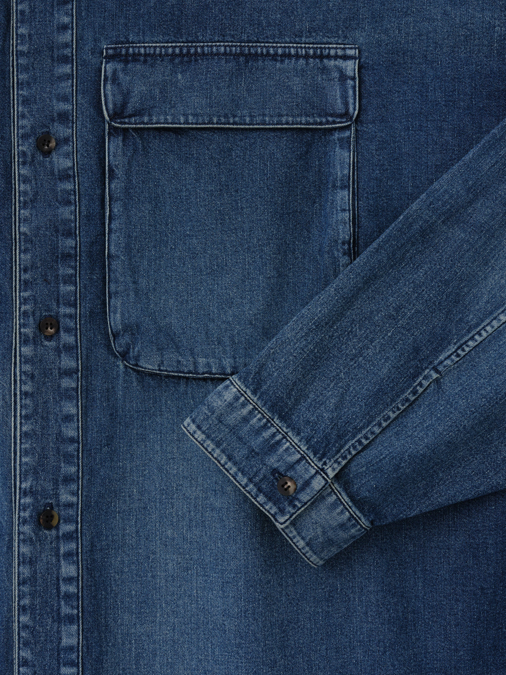 Denim Military Shirt in blue denim shown in close detail with a flap chest pocket button front and button cuff as Tops