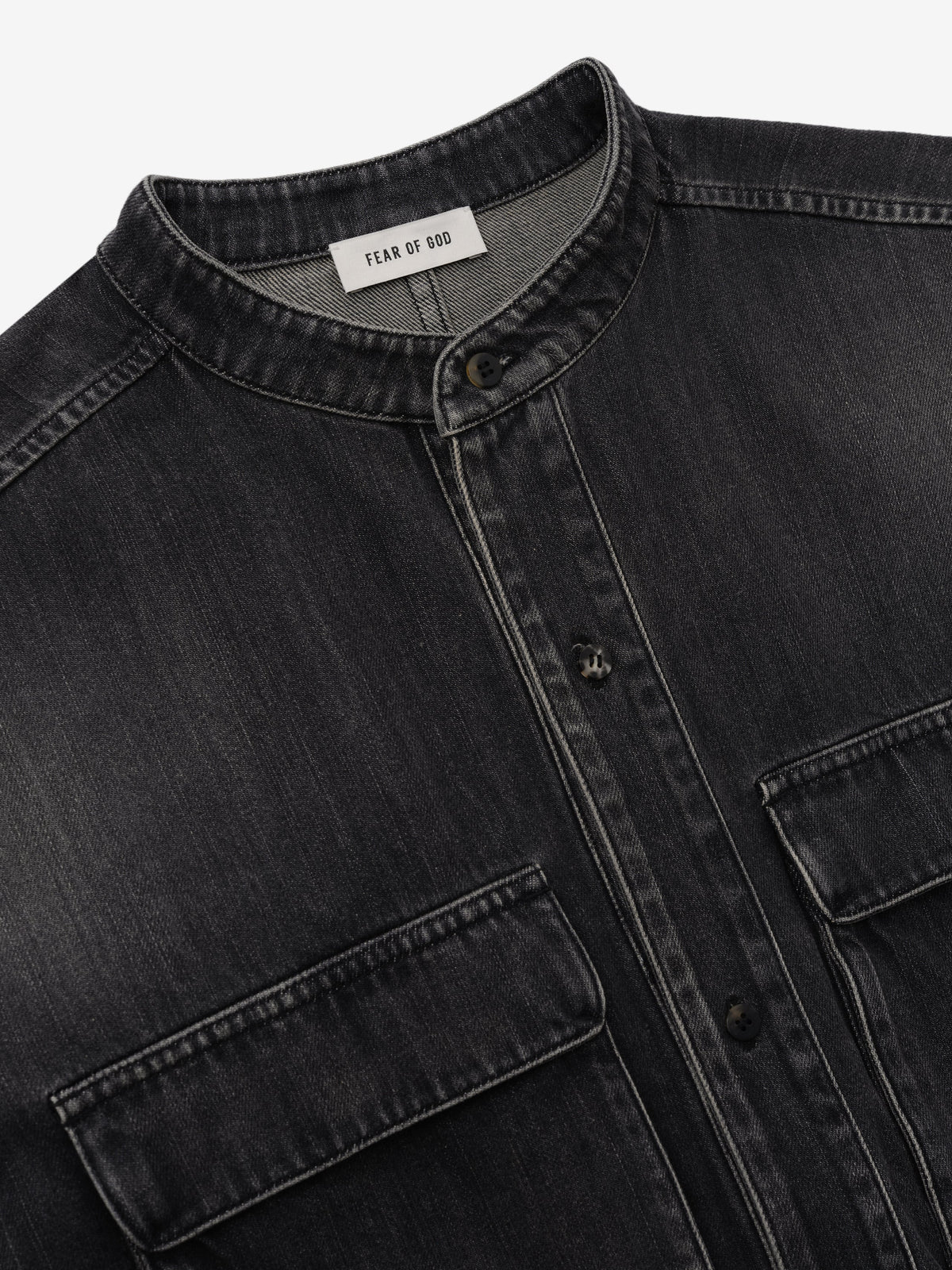 Denim Military Shirt in dark gray denim shown in close detail with a stand collar button front flap chest pockets and Fear of God label as Tops