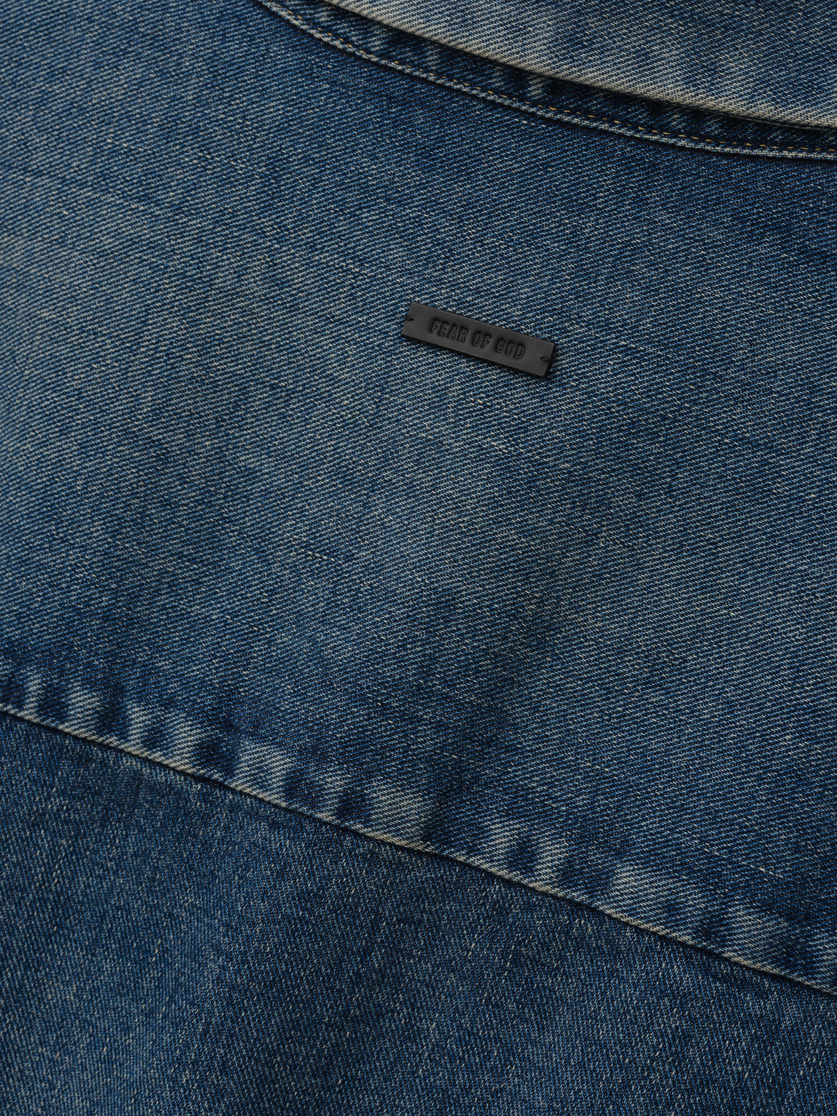 Denim Relaxed Fit Shirt in blue denim shown in close detail with tonal stitching a curved seam and Fear of God label as Tops