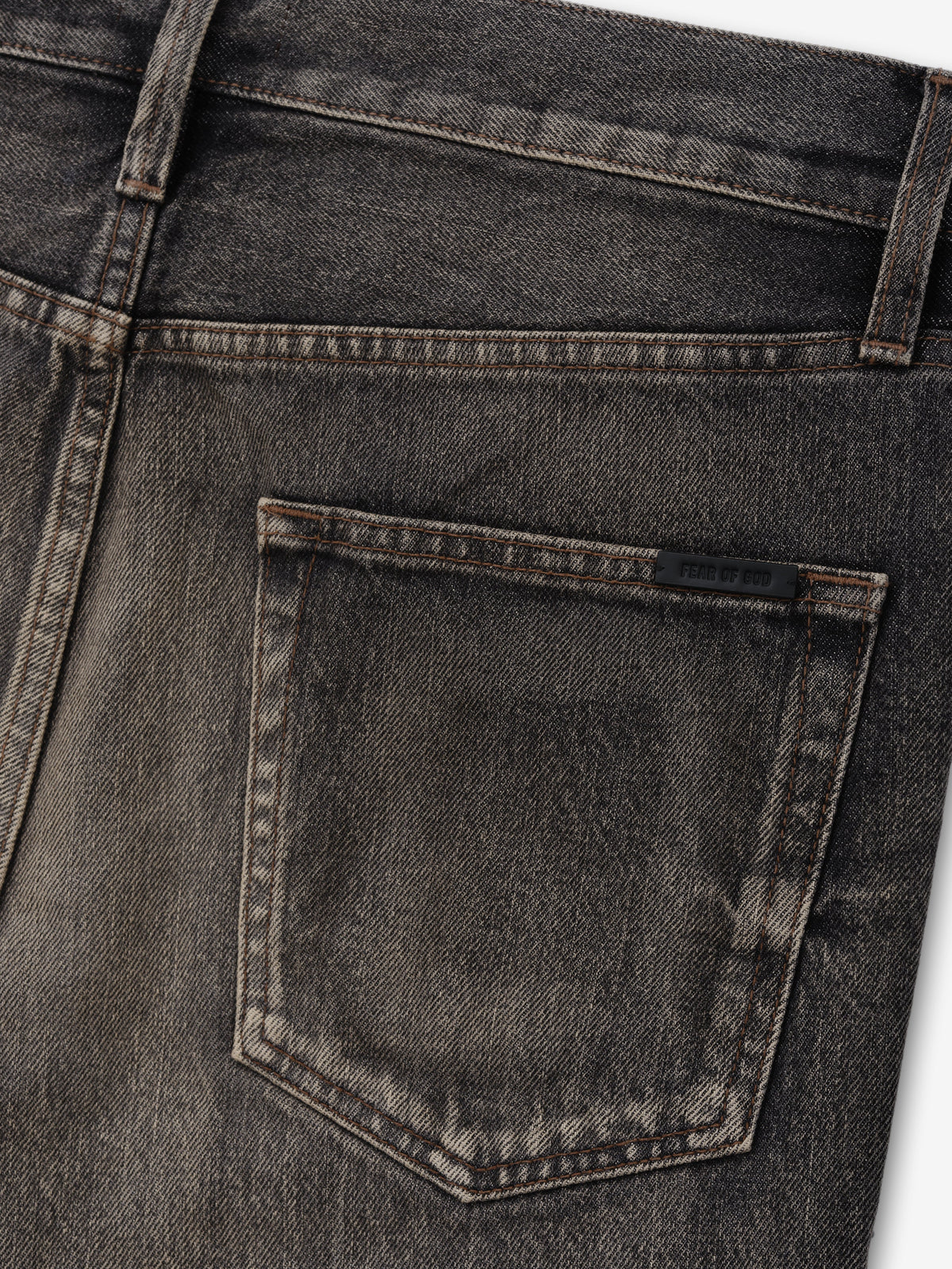 Flared Jeans in washed charcoal denim close detail of a rear patch pocket with tonal stitching belt loop and subtle fading as Bottoms