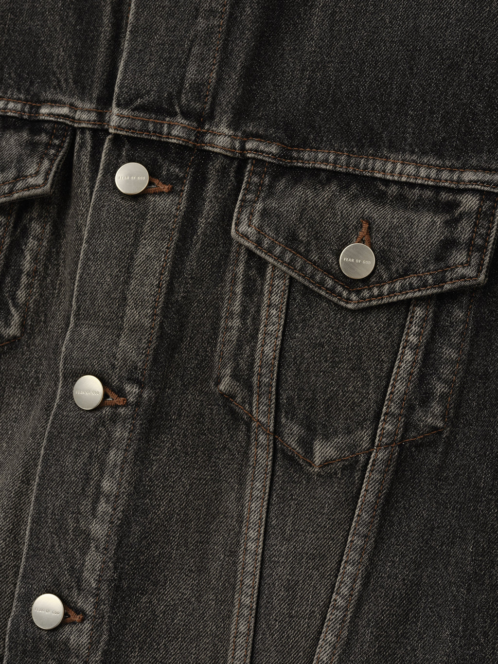 Denim Trucker Jacket in dark washed denim close-up showing metal buttons a flap chest pocket contrast stitching and textured twill as Outerwear