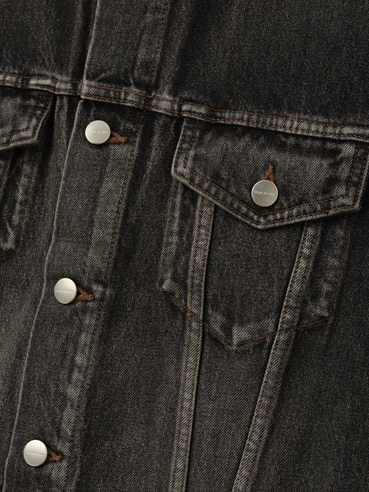 Denim Trucker Jacket in dark washed denim close-up showing metal buttons a flap chest pocket contrast stitching and textured twill as Outerwear