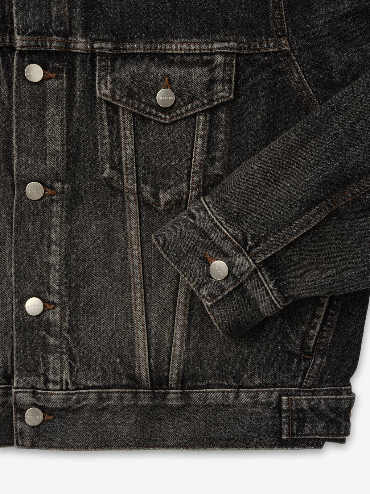 Denim Trucker Jacket in dark washed denim close up showing button front flap chest pocket contrast stitching sleeve cuff and waistband as Outerwear