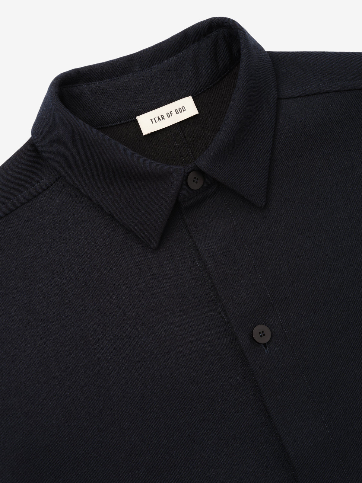 Double Weave Cotton Wool Overshirt shown close up in black with pointed collar button placket and Fear of God neck label as Tops