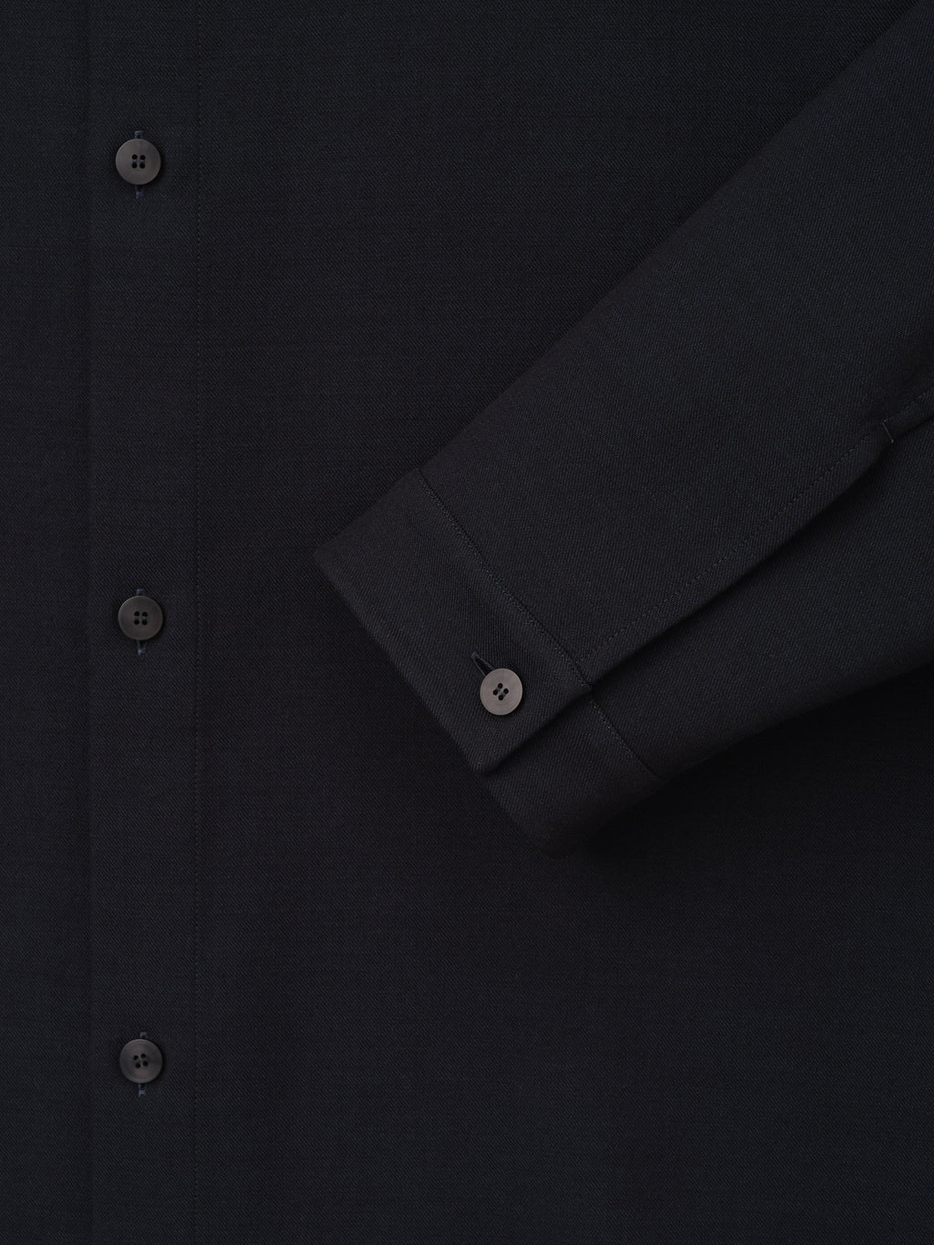 Double Weave Cotton Wool Overshirt shown close up in black with tonal buttons button front and cuffed sleeve as Tops