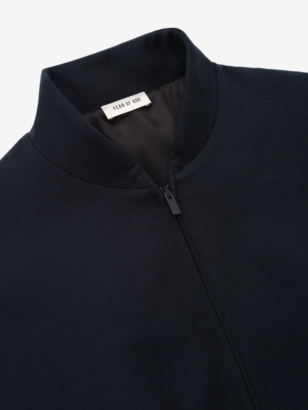 Double Weave Cotton Wool Eternal Bomber shown close up in dark navy with a stand collar concealed zip front and Fear of God neck label as Outerwear