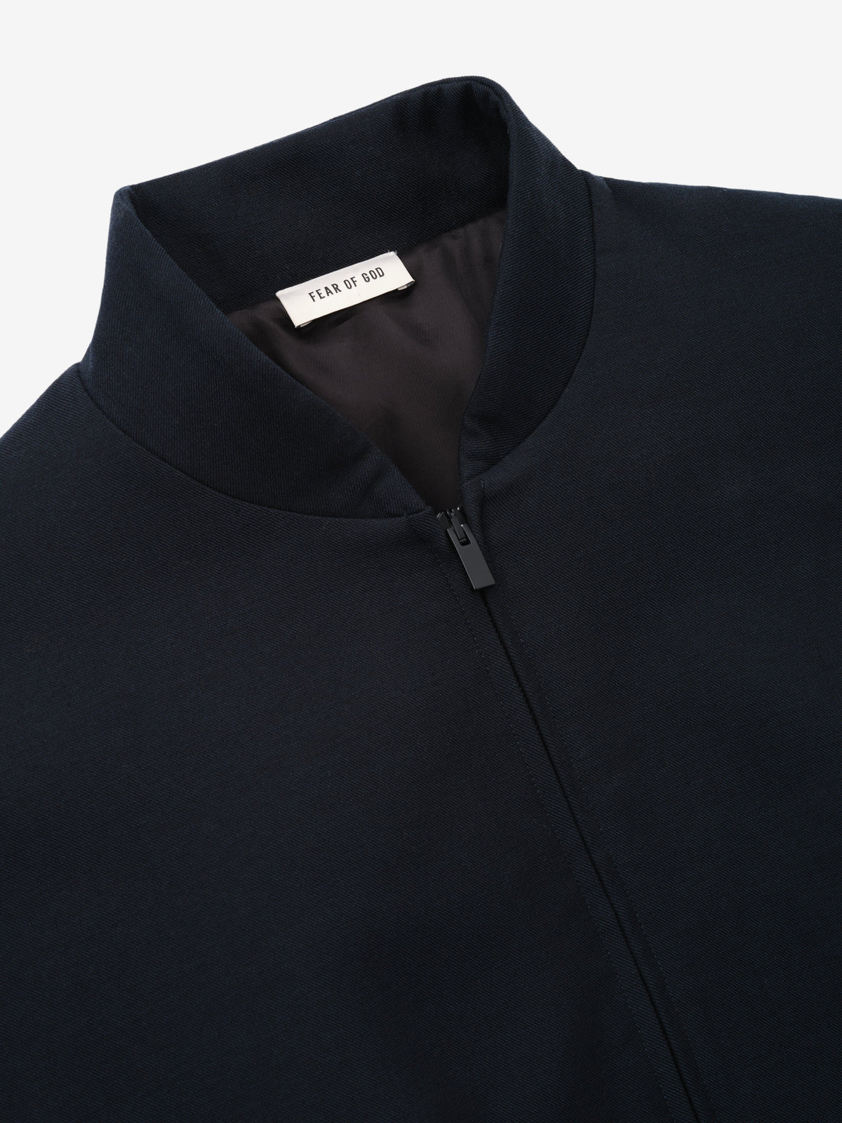 Double Weave Cotton Wool Eternal Bomber shown close up in dark navy with a stand collar concealed zip front and Fear of God neck label as Outerwear
