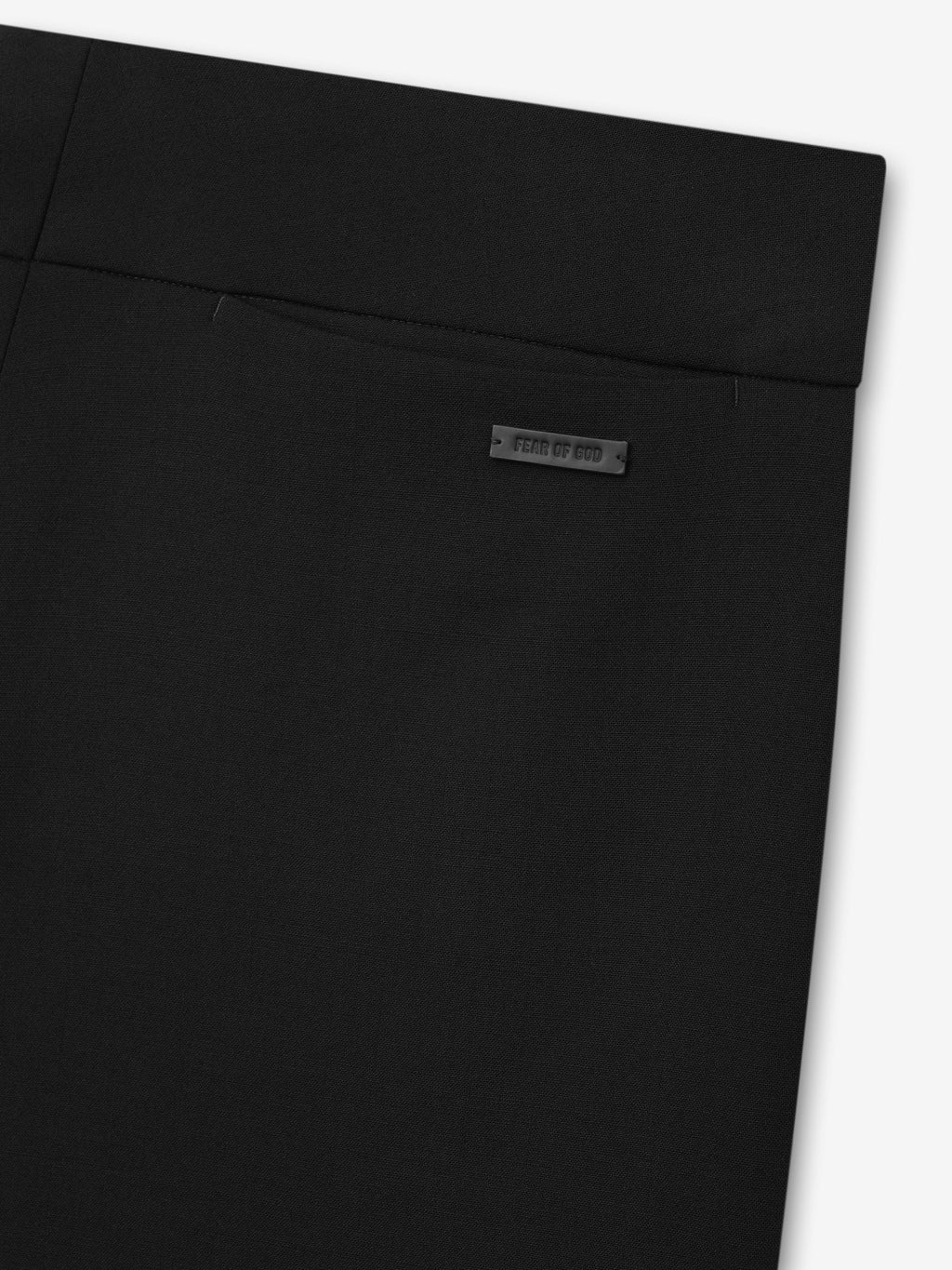 Double Weave Wool Flared Flat Front Pants close up in black showing the high waistband angled pocket seam and Fear of God label as Bottoms