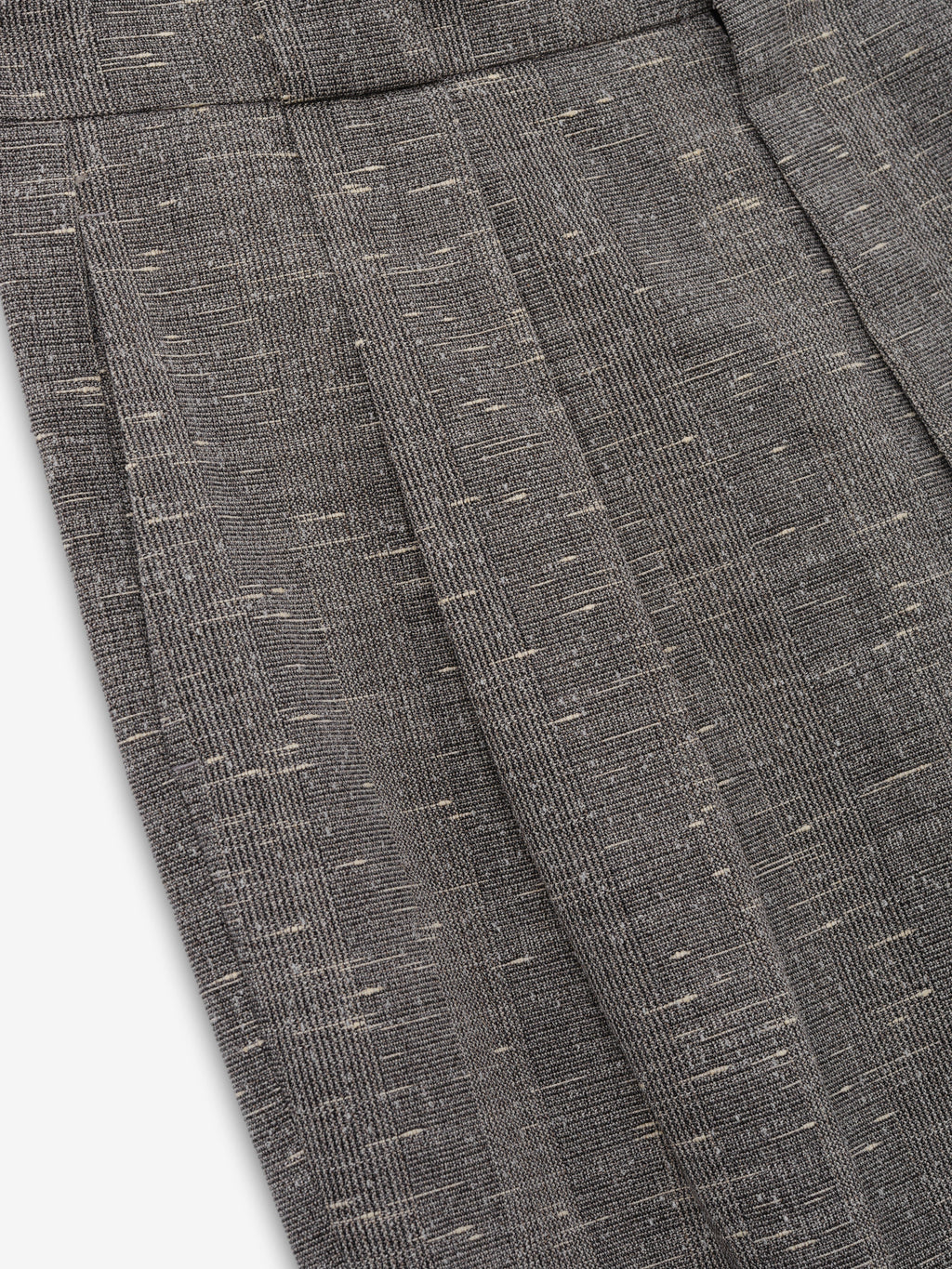 Slub Wool Box Pleat Trousers close up in textured charcoal gray showing the front box pleat and flecked slub wool weave as Bottoms