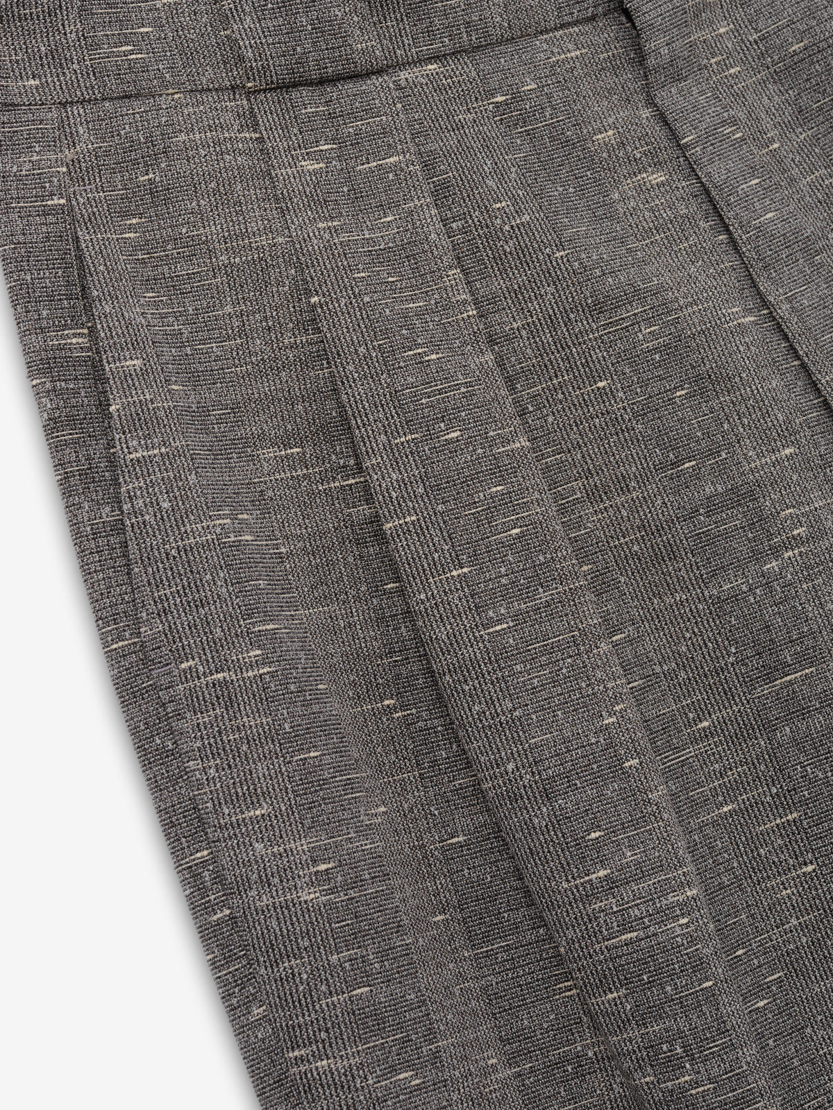 Slub Wool Box Pleat Trousers close up in textured charcoal gray showing the front box pleat and flecked slub wool weave as Bottoms