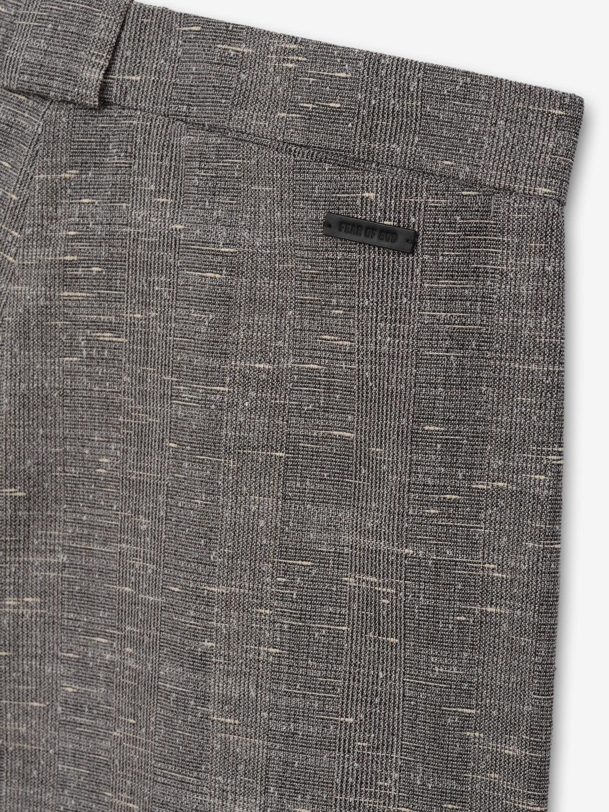 Slub Wool Box Pleat Trousers close up in charcoal gray showing the waistband and flecked slub wool weave as Bottoms