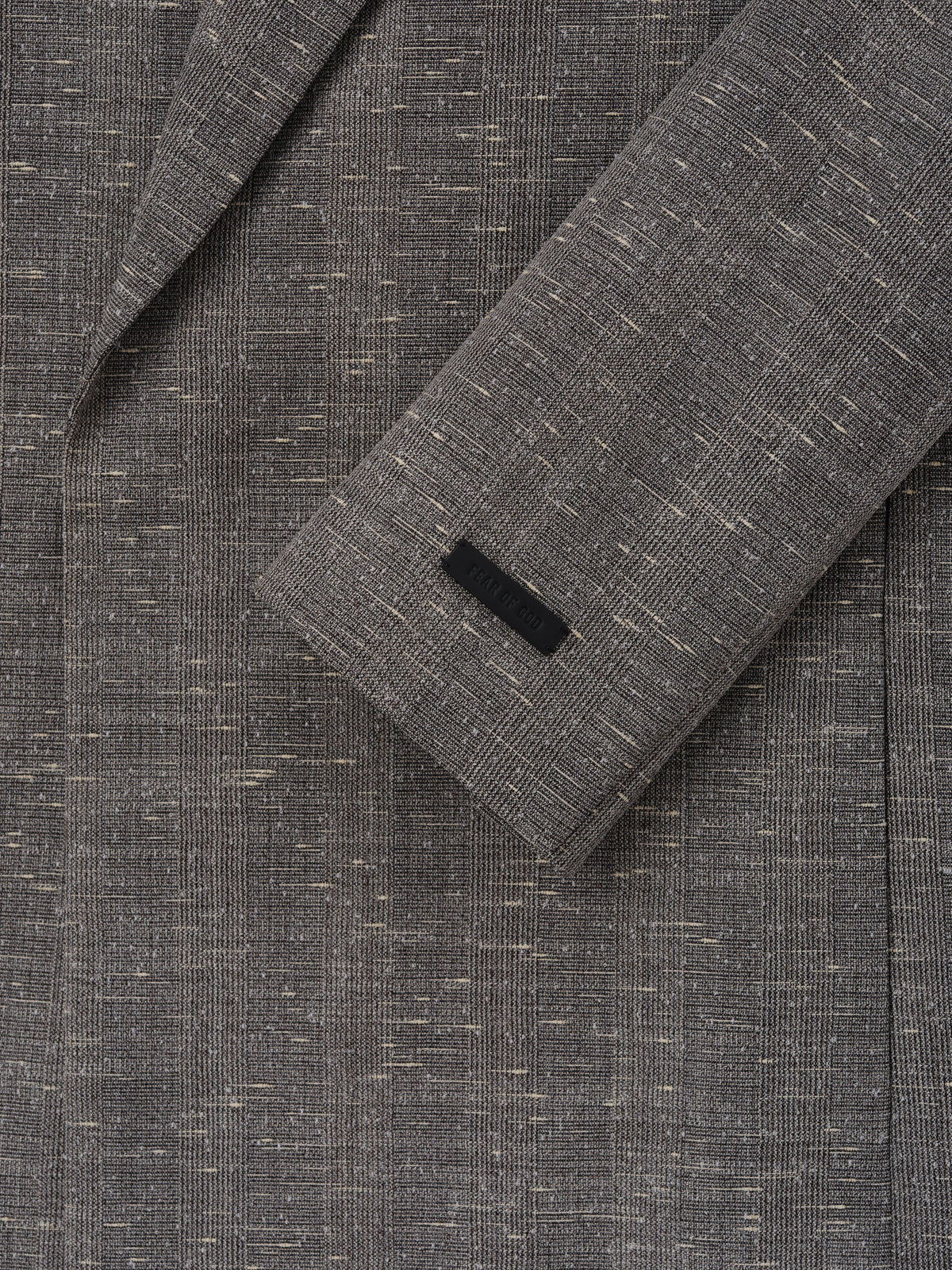 Slub Wool Cotton Belted Jacket close up in textured gray showing the sleeve cuff and flecked woven fabric as Outerwear