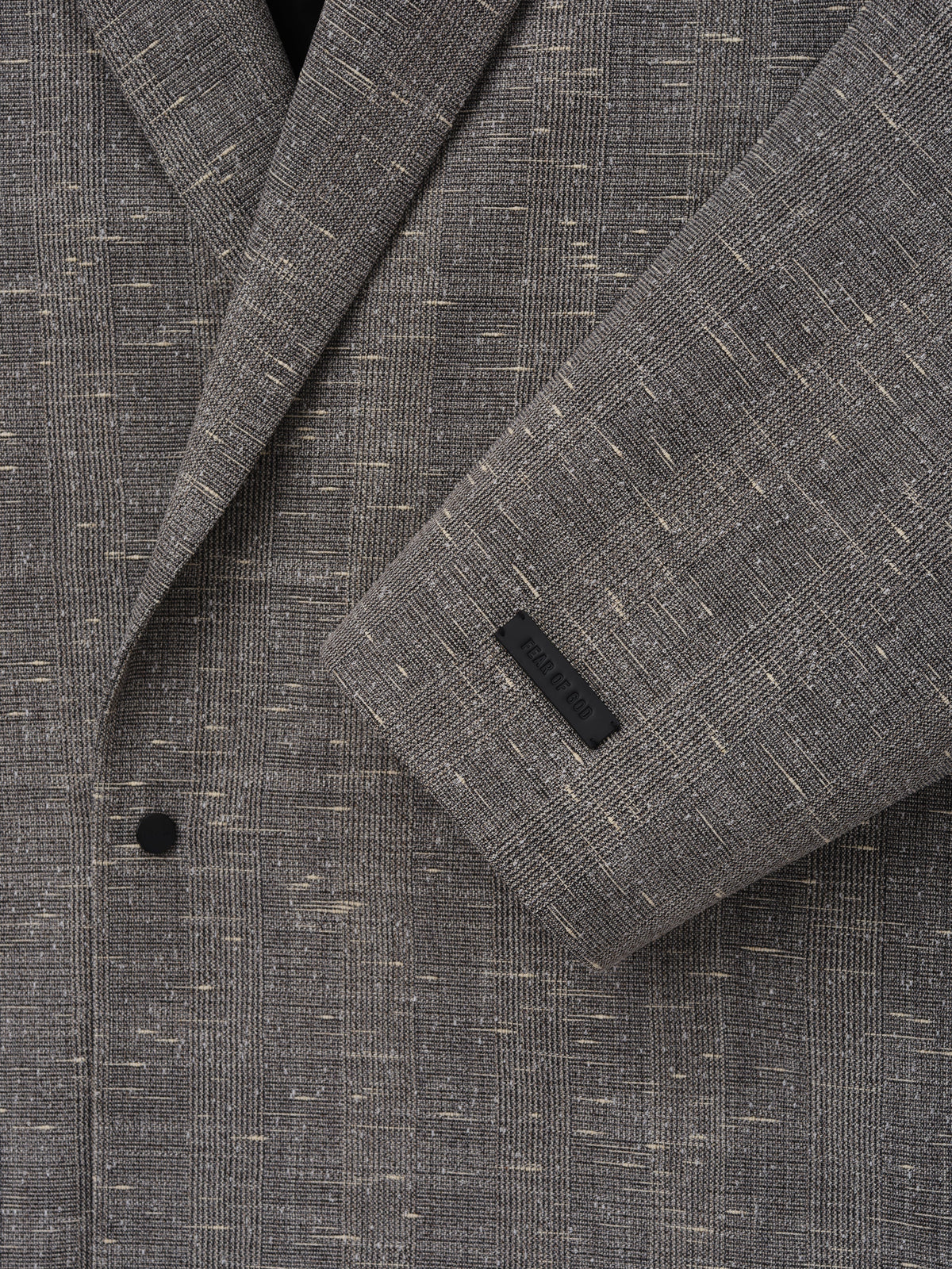 Slub Wool Cotton Relaxed Jacket close up in textured gray showing the notched lapel black button sleeve cuff and woven fabric detail as Outerwear