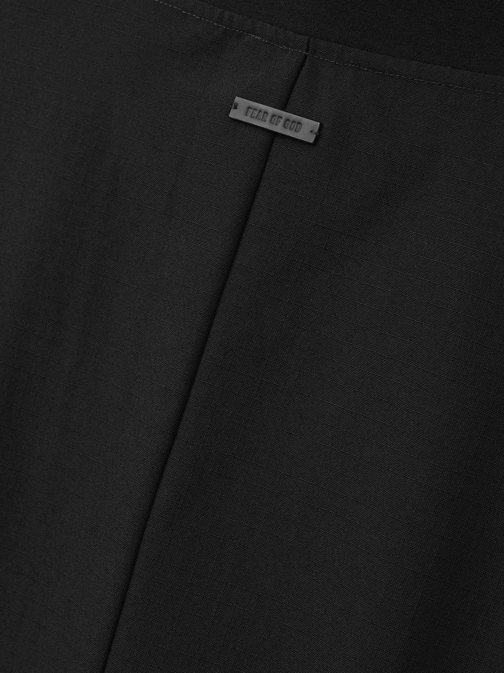Wool Ripstop Pullover Shirt close up in black highlighting the central seam subtle ripstop texture and Fear of God label as Tops