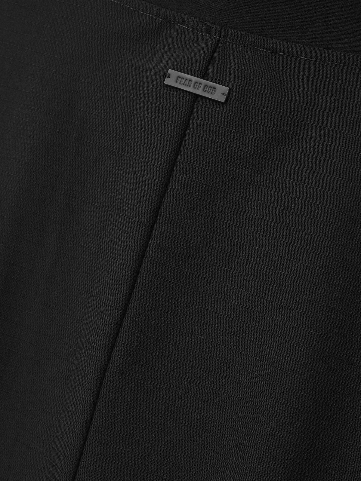 Wool Ripstop Pullover Shirt close up in black highlighting the central seam subtle ripstop texture and Fear of God label as Tops
