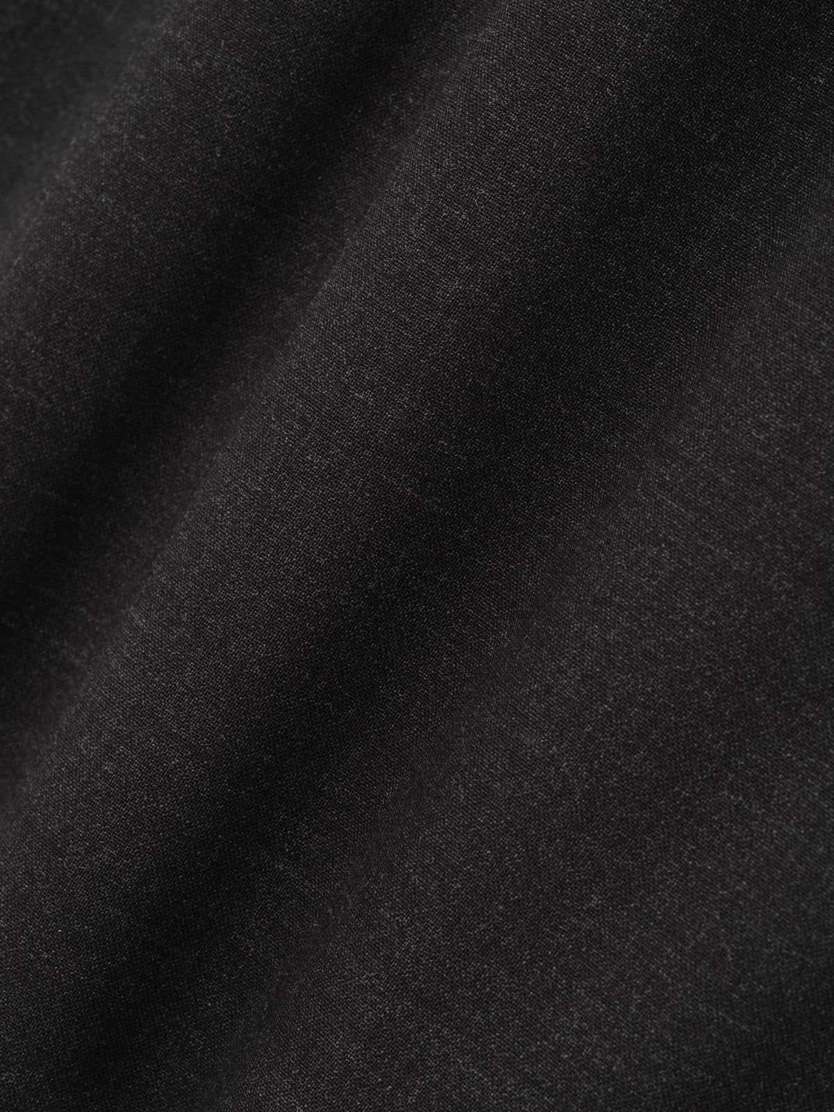 Melange Wool Relaxed Jacket close up in black highlighting the soft textured wool surface and subtle melange finish as Outerwear