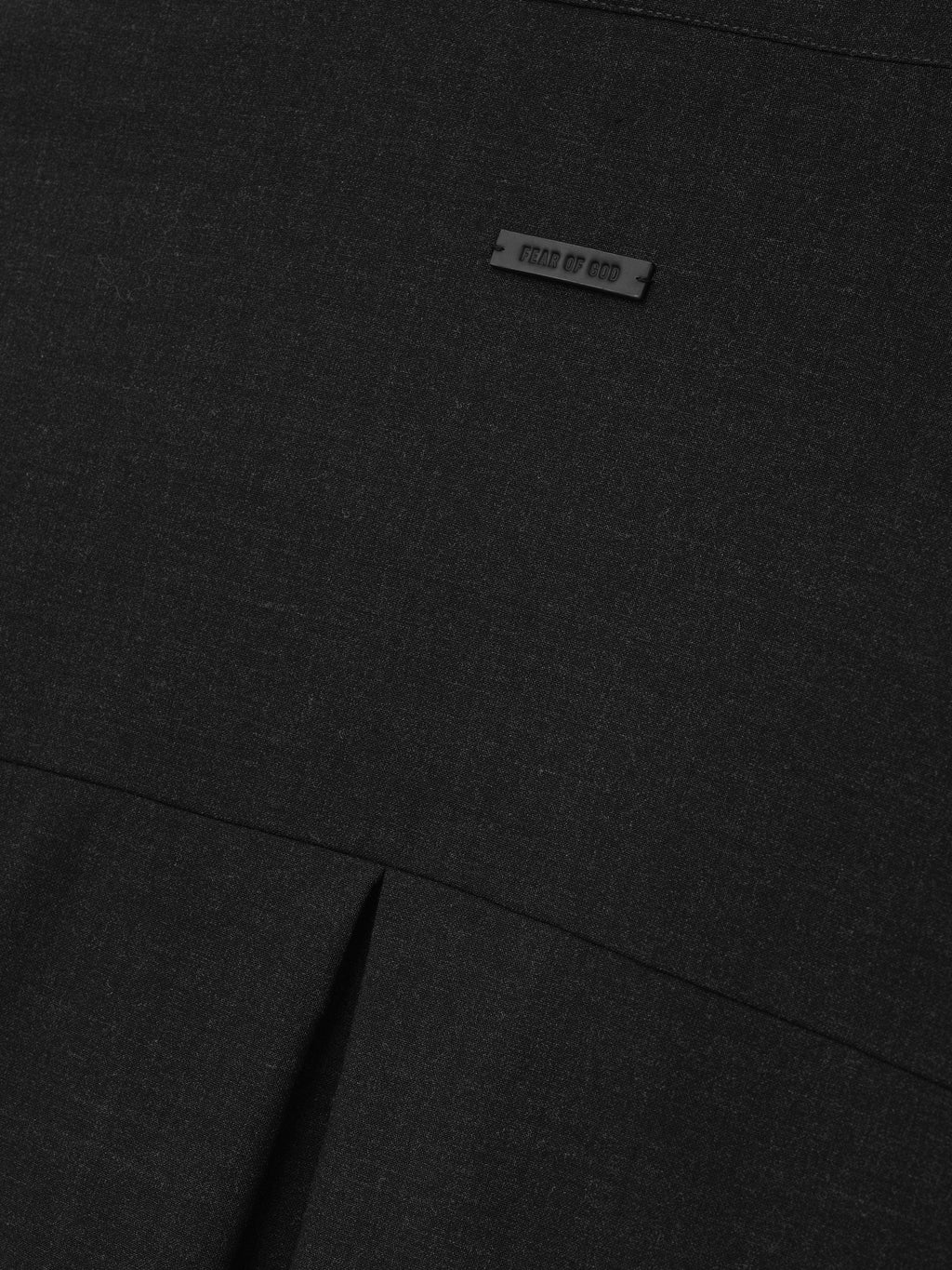 Melange Wool Pullover Shirt close up in black showing the Fear of God label fine wool texture and pleated seam detail as Tops