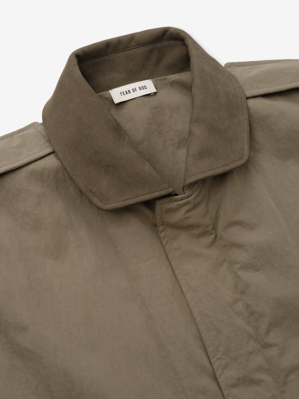 Washed Cotton Nylon Gabardine Field Jacket close up in taupe showing its spread collar concealed closure and Fear of God label as Outerwear