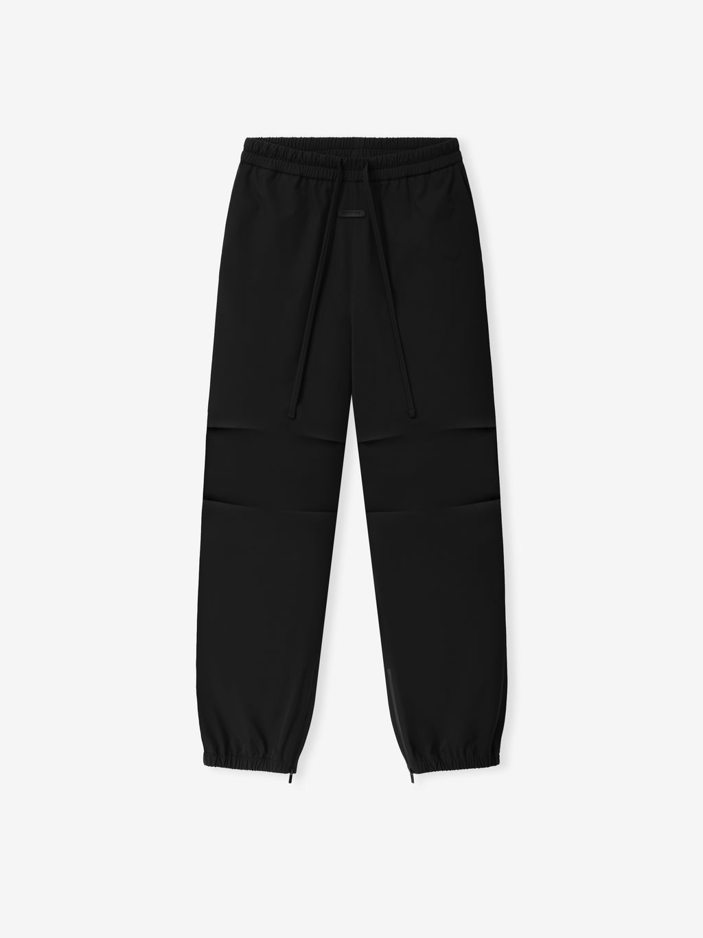 Bonded Nylon Track Pant shown flat in black with an elastic drawstring waist articulated knees tapered legs and zip cuffs as Bottoms