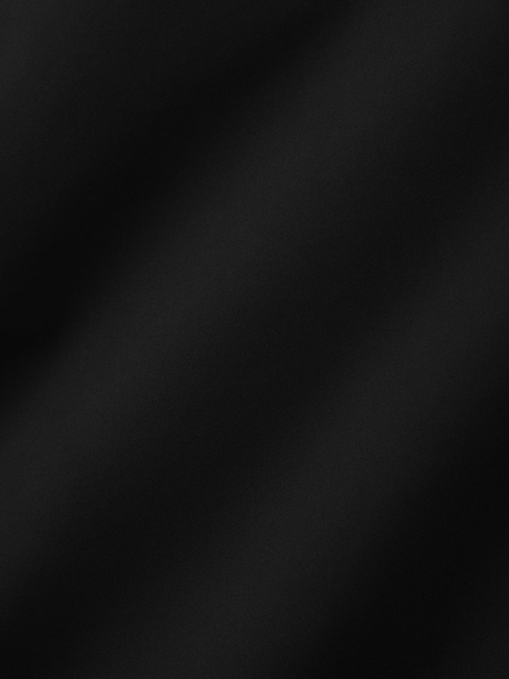 Bonded Nylon Track Pant close up in black revealing the smooth bonded nylon fabric texture as Bottoms