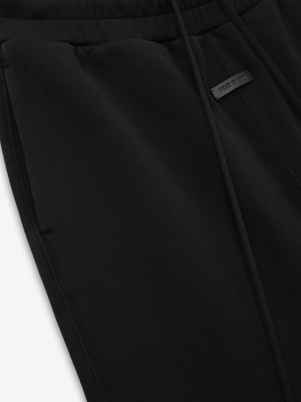 Fleece Basketball Shorts in black shown close up with an elastic drawstring waistband angled side pocket seam and small woven label as Bottoms