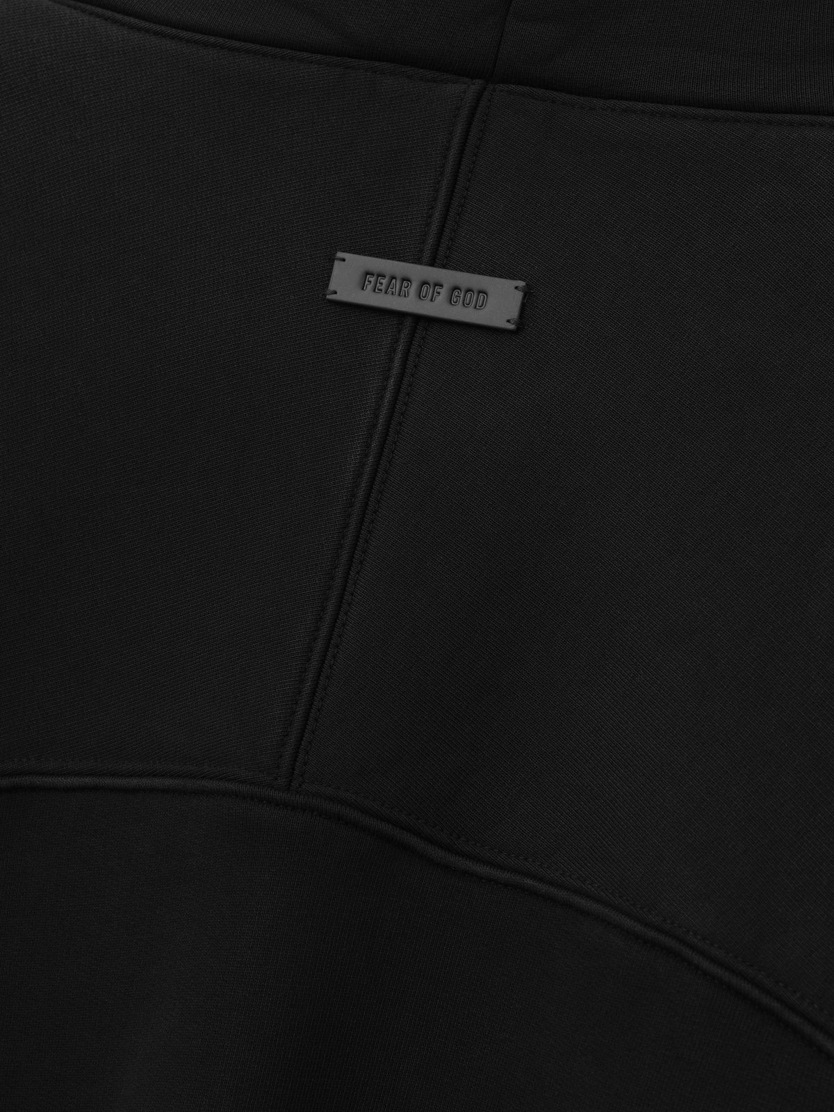 Raglan Funnel Neck Sweatshirt in black shown close up with a Fear of God label and curved stitched chest yoke seam revealing textured fleece as Tops