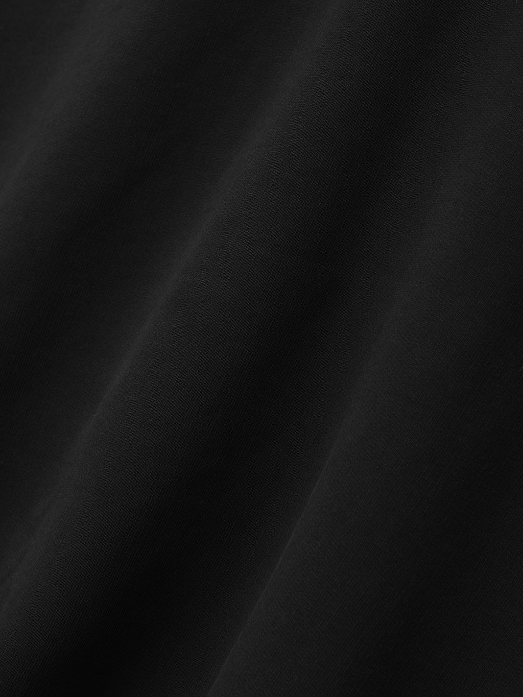 Raglan Funnel Neck Sweatshirt in black shown in close detail with softly folded fabric and a subtle fleece texture as Tops