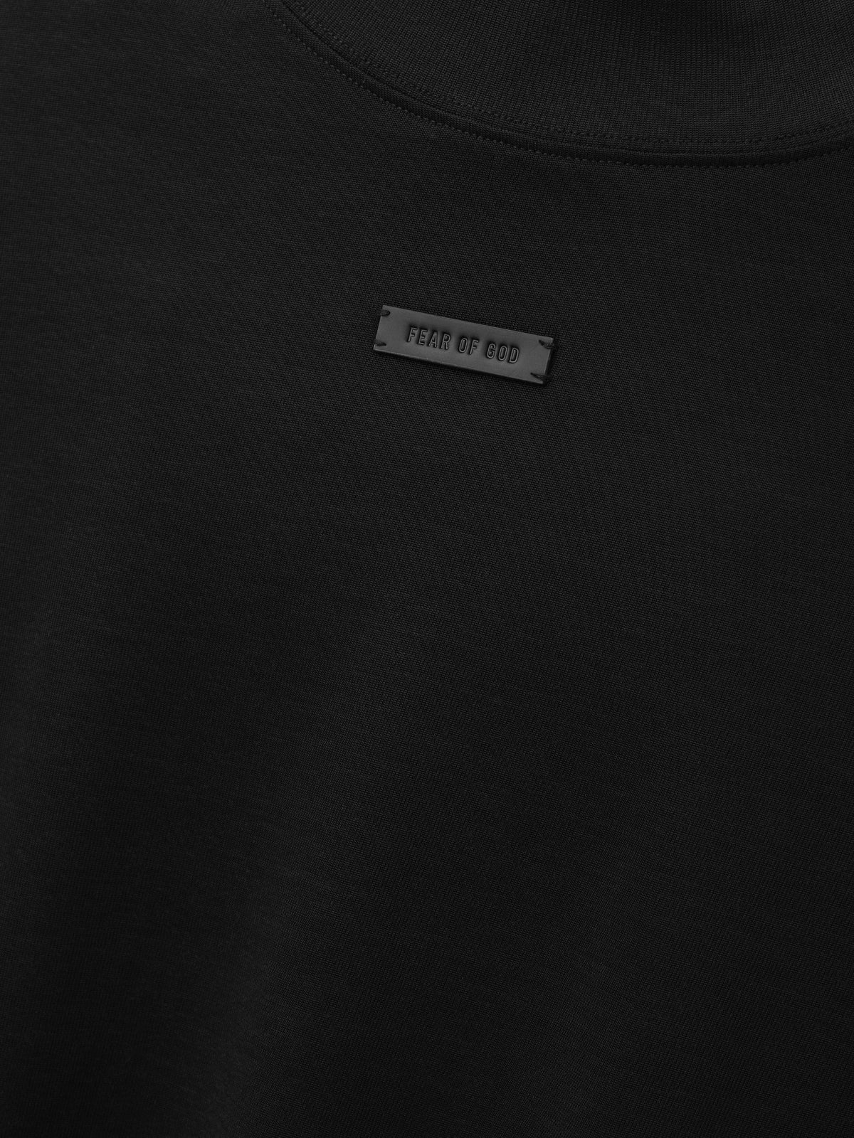 Cotton Rayon Mockneck Short Sleeve Tee in black shown in close detail with mockneck collar and Fear of God label as Tops